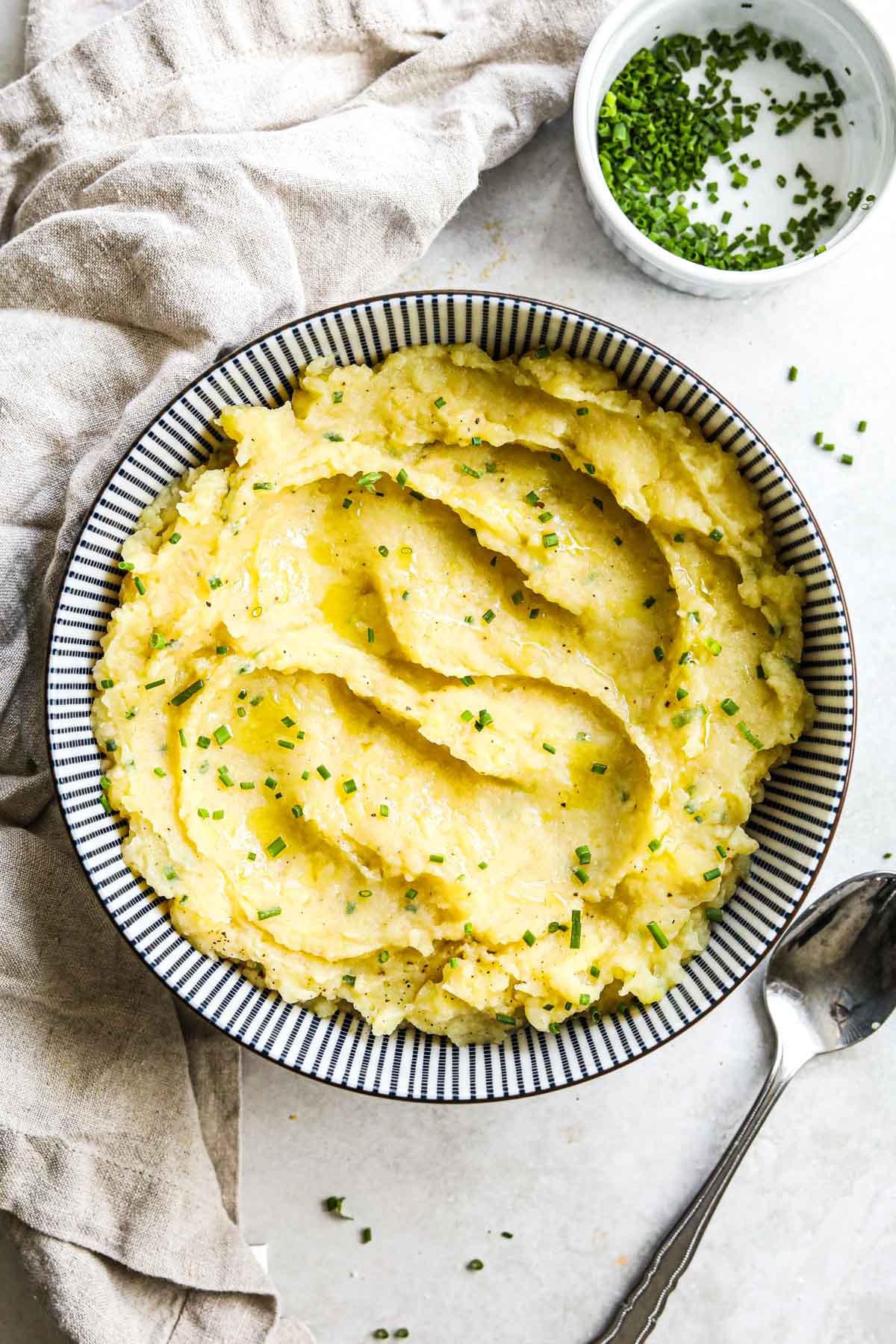 The best dairy-free vegan garlic mashed potatoes made without any milk in a blue and white porcelain bowl.