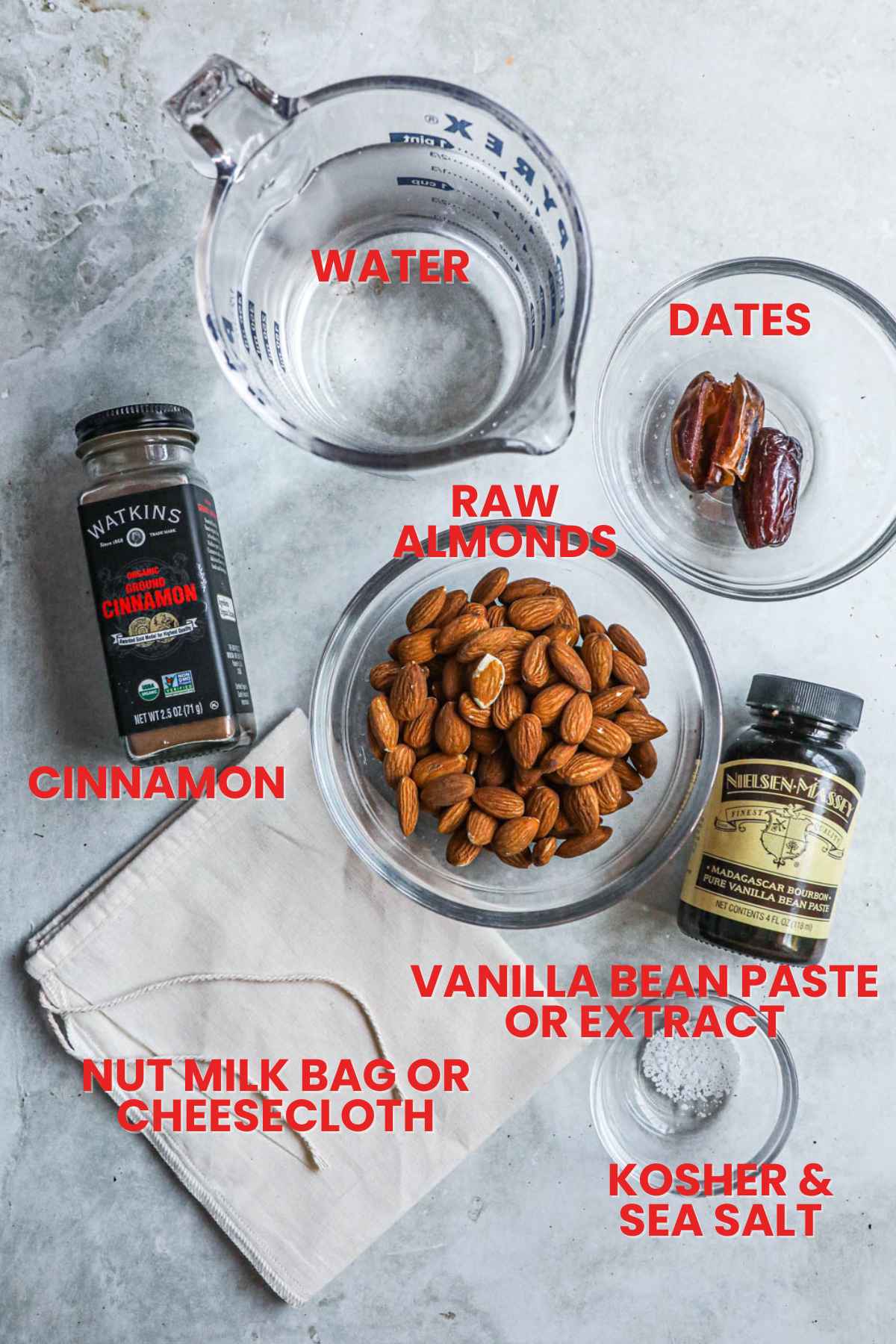 Ingredients to make spiced Vitamix almond milk, raw almonds, cinnamon, dates, water, vanilla bean paste or extract, salt, nut milk bag.